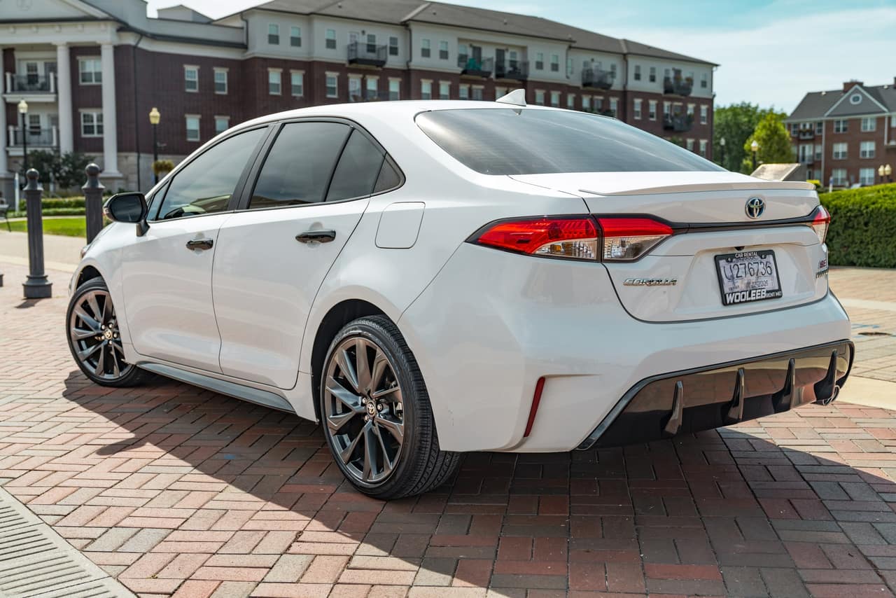 Rear three-quarter view of the white Toyota Corolla Hybrid SE