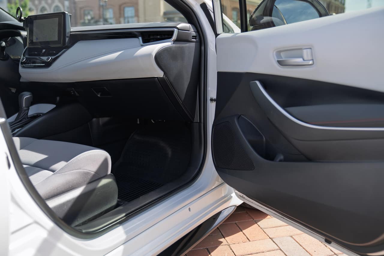 Toyota Corolla passenger footwell, dashboard, and open front door